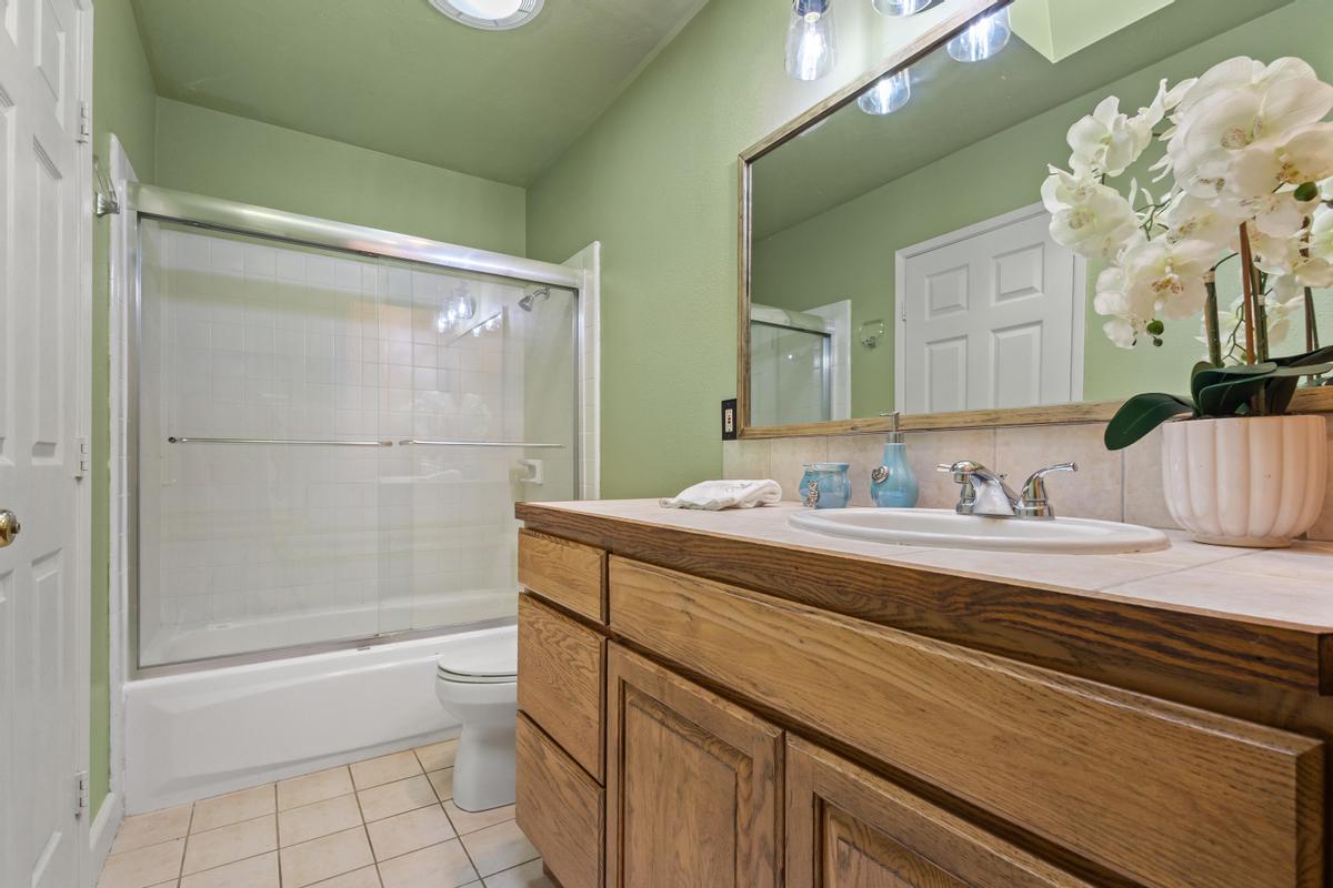 77-6484 Ono Road Kailua-Kona, HI 96740 - Photo 23 of 29 a bathroom with a granite countertop sink a toilet and shower