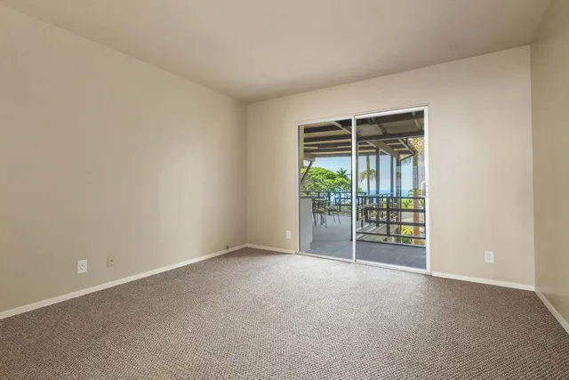 a view of an empty room with glass door