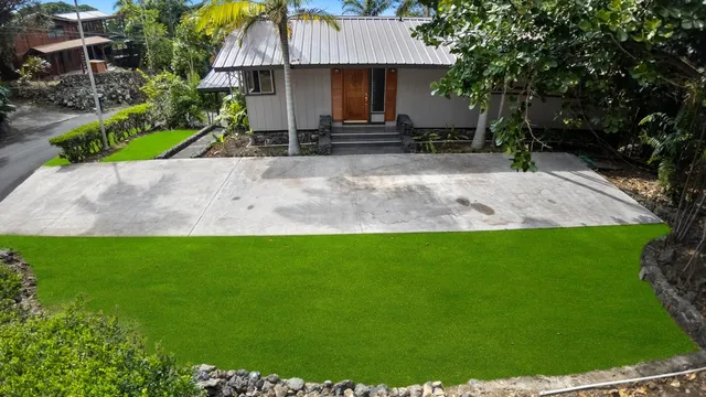 a view of a house with a yard and tree