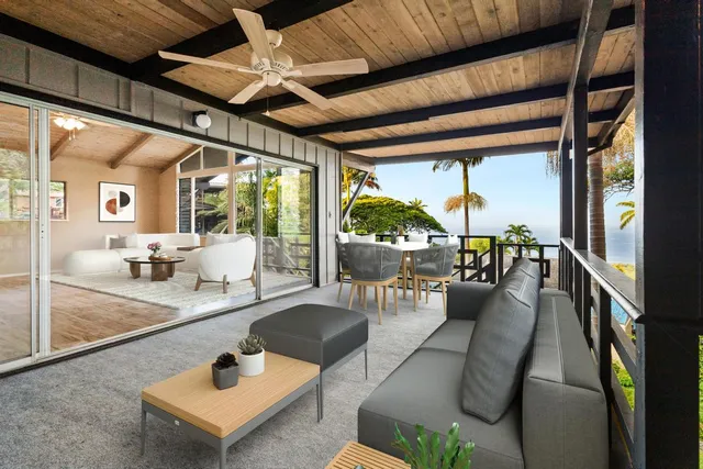 a living room with furniture and a floor to ceiling window