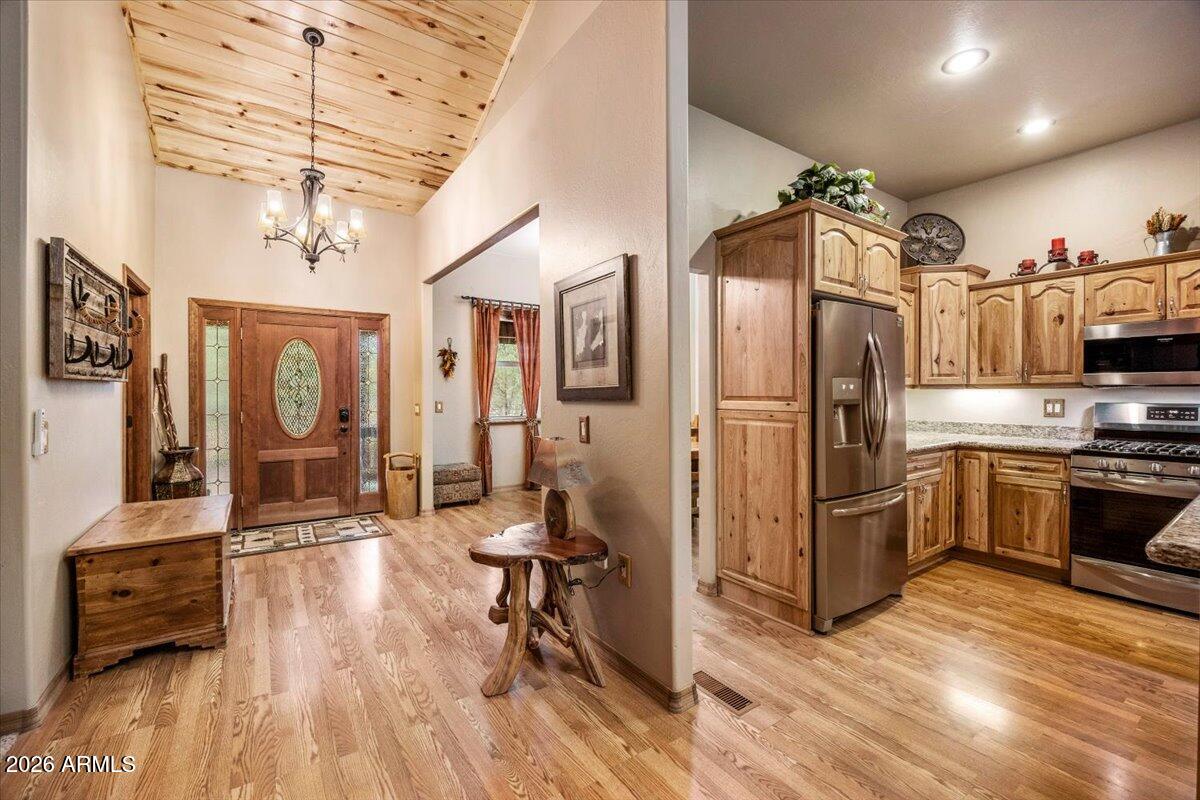 2952 Country View Lane Overgaard, AZ 85933 - Photo 11 of 81 a kitchen with stainless steel appliances a refrigerator and wooden floor