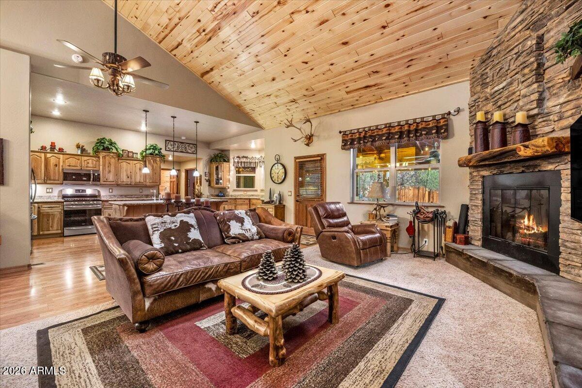 2952 Country View Lane Overgaard, AZ 85933 - Photo 15 of 81 a living room with furniture a fireplace and a chandelier