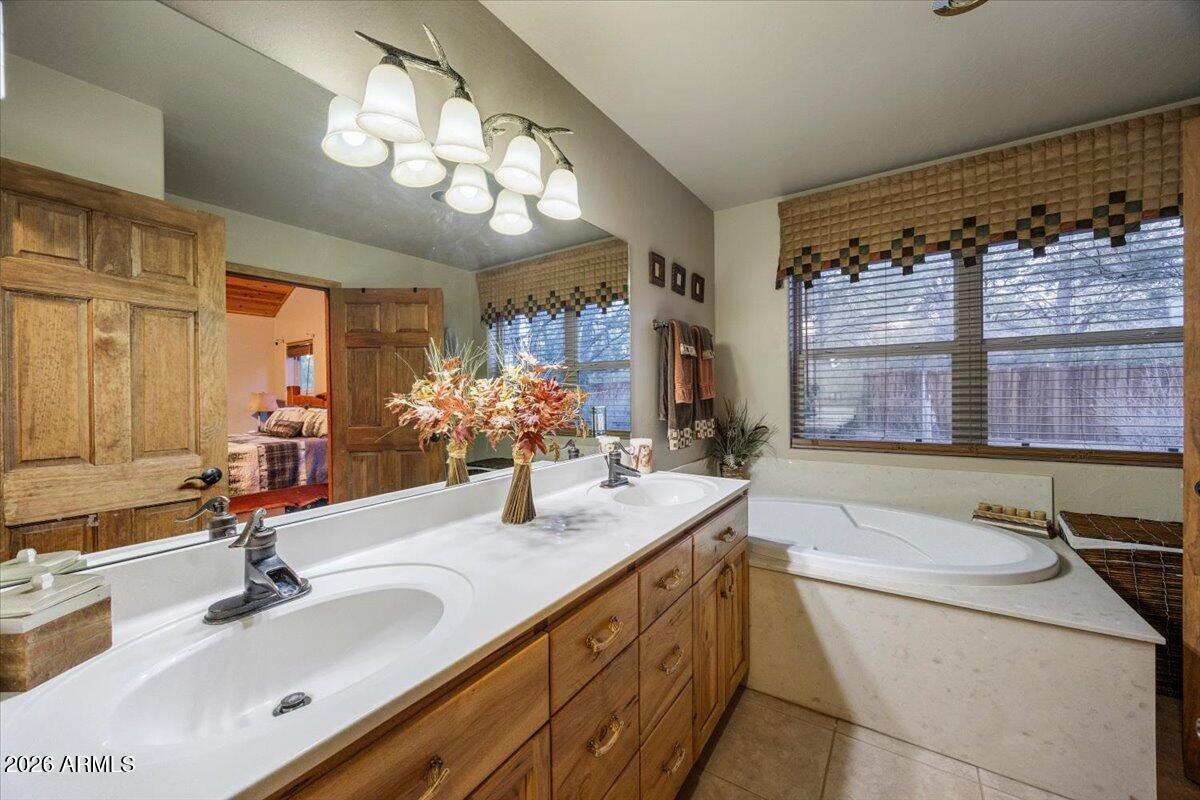 2952 Country View Lane Overgaard, AZ 85933 - Photo 27 of 81 a bathroom with a granite countertop sink and a large mirror