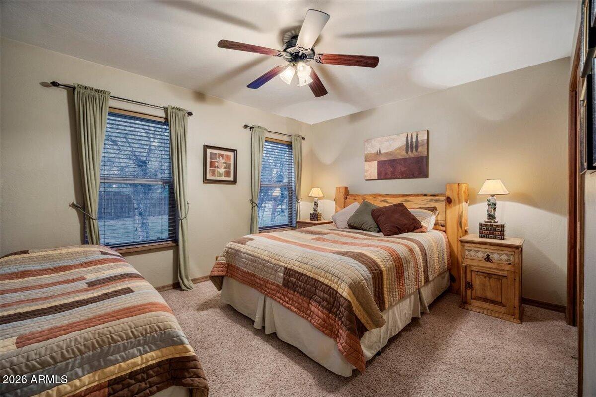 2952 Country View Lane Overgaard, AZ 85933 - Photo 31 of 81 a bedroom with bed and a chandelier