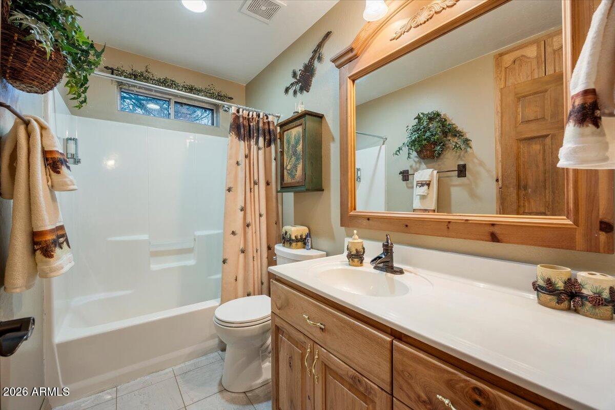 2952 Country View Lane Overgaard, AZ 85933 - Photo 32 of 81 a bathroom with a granite countertop sink toilet and shower