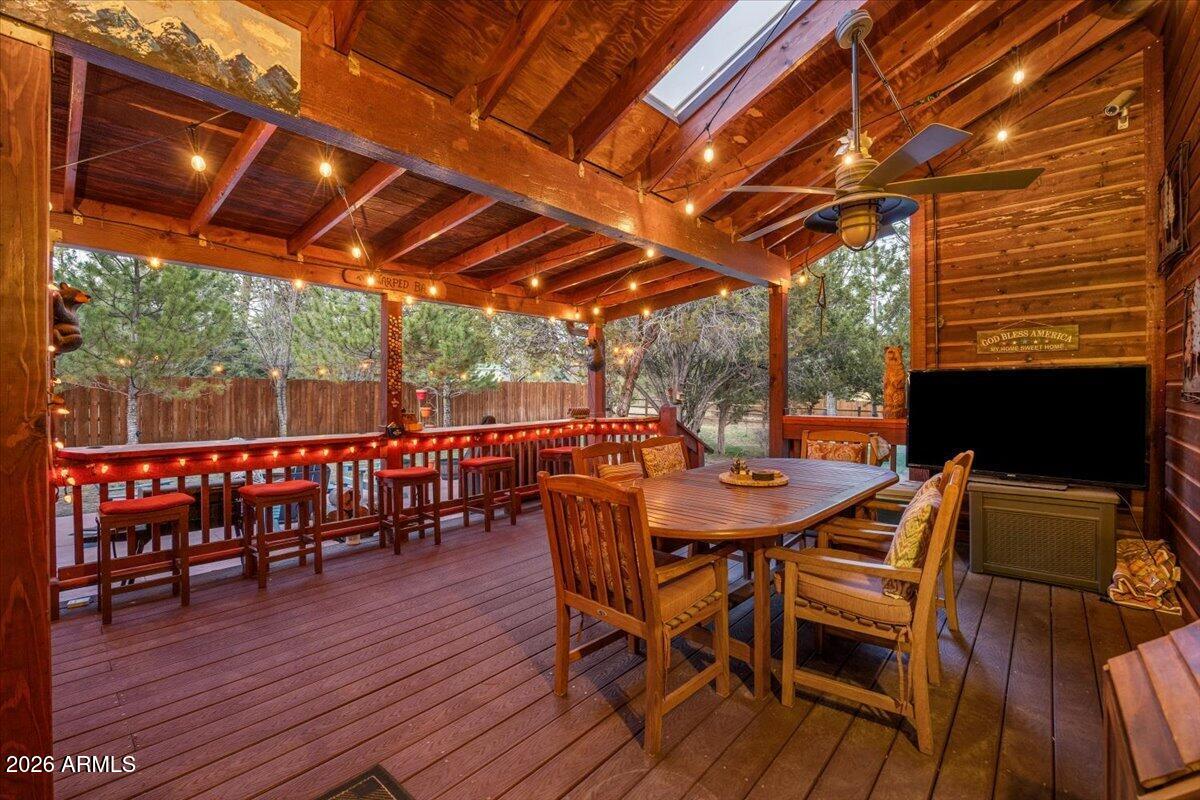 2952 Country View Lane Overgaard, AZ 85933 - Photo 38 of 81 a view of a patio with table and chairs with wooden floor and fence