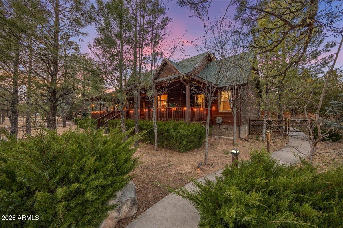 2952 Country View Lane Overgaard, AZ 85933 - Photo 6 of 81 a view of a patio with table and chairs under an umbrella