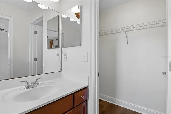 a bathroom with a sink a vanity a mirror and a shower