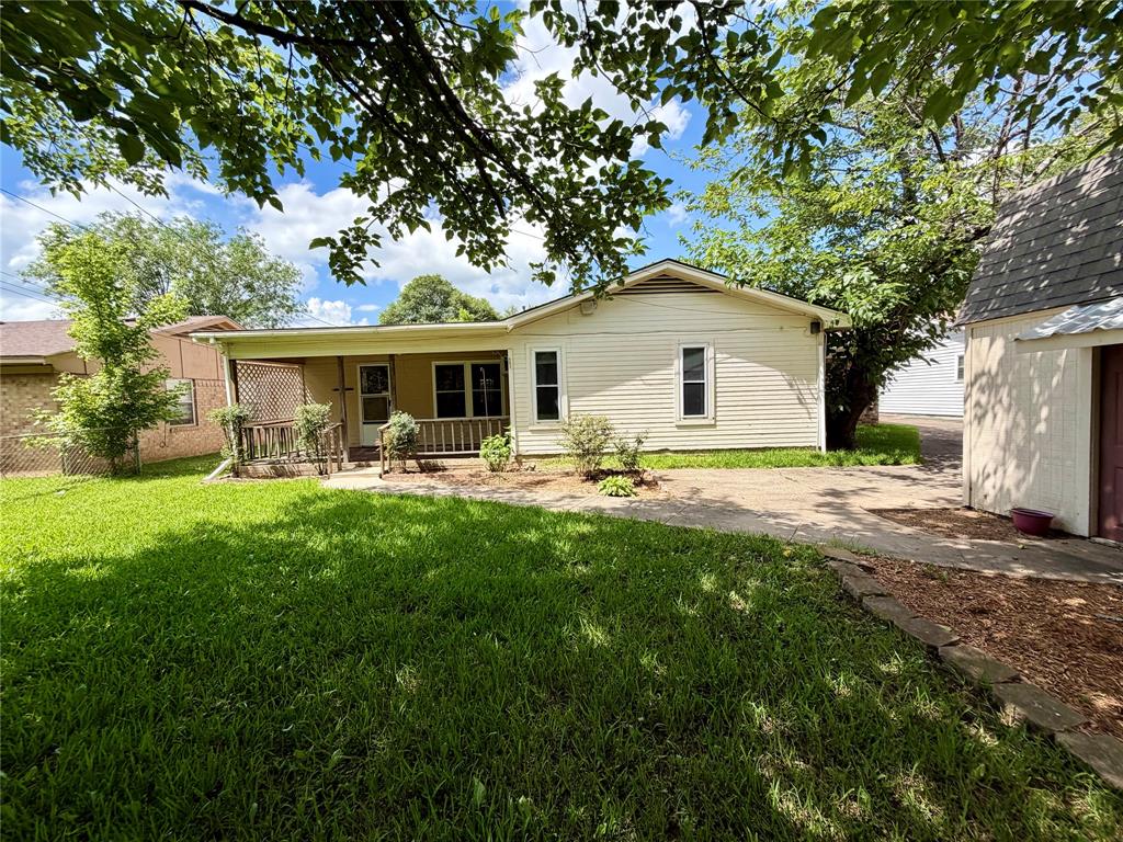 2030 Sycamore Street Paris, TX 75460 - Photo 21 of 24 Single-story exterior with horizontal siding and a covered front porch featuring a wooden railing