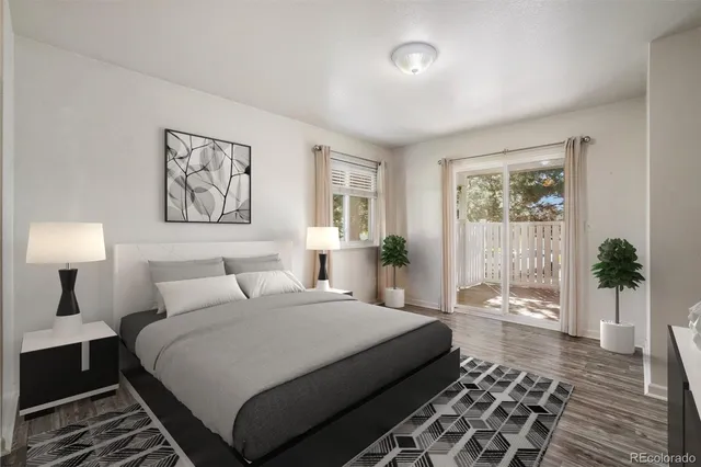 a bedroom with a balcony a bed and a painting on the wall