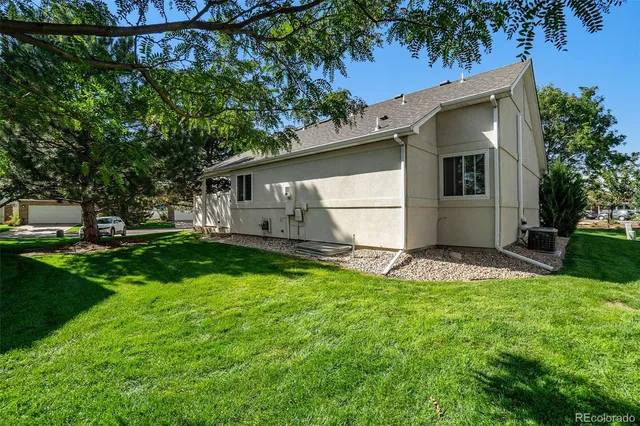 a view of backyard of house with green space
