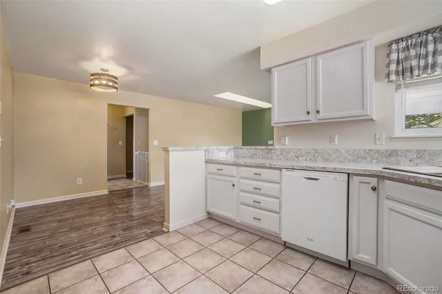 a kitchen with granite countertop cabinets and window