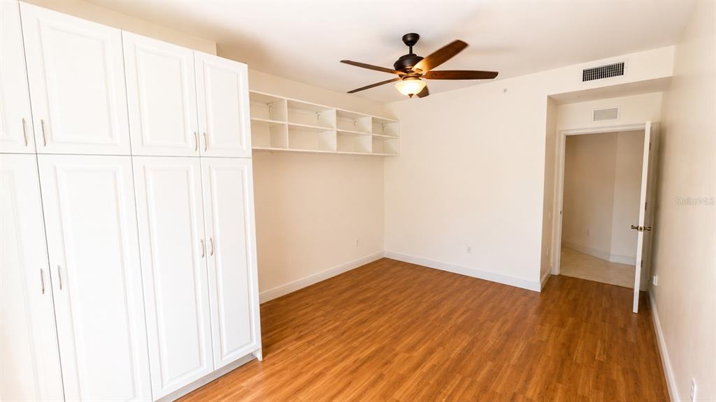 6552 Moorings Point Circle, Unit 102 Lakewood Ranch, FL 34202 - Photo 30 of 57 a view of empty room with wooden floor and fan