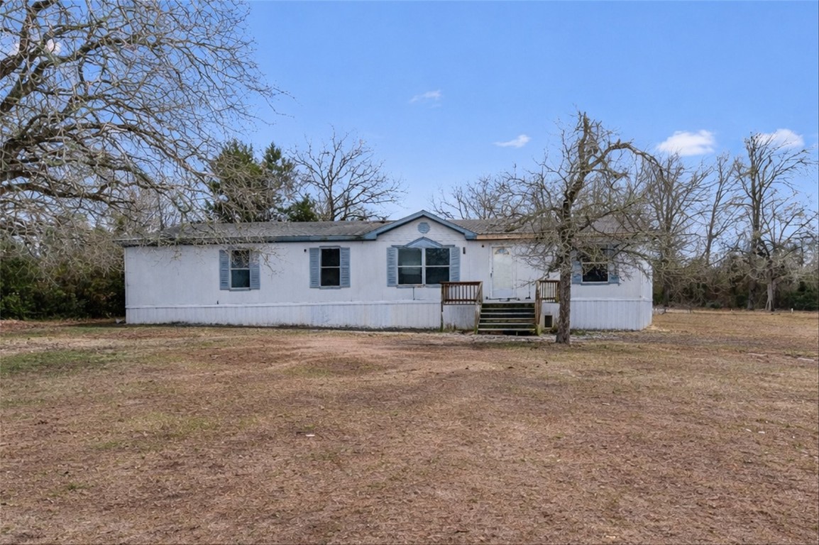 a view of a house with a yard and garage