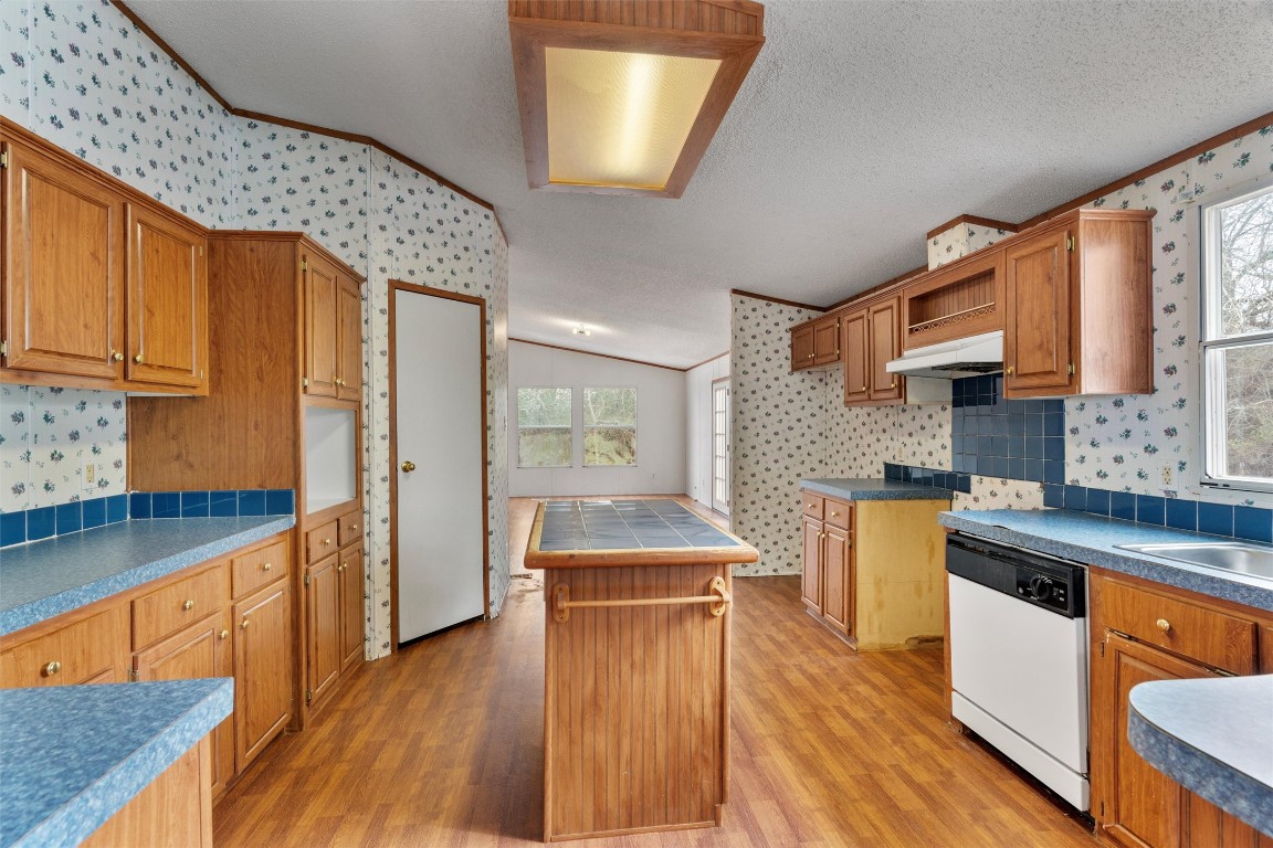 1100 County Road 474 Elgin, TX 78621 - Photo 16 of 40 a kitchen with stainless steel appliances granite countertop wooden floors a sink and a stove