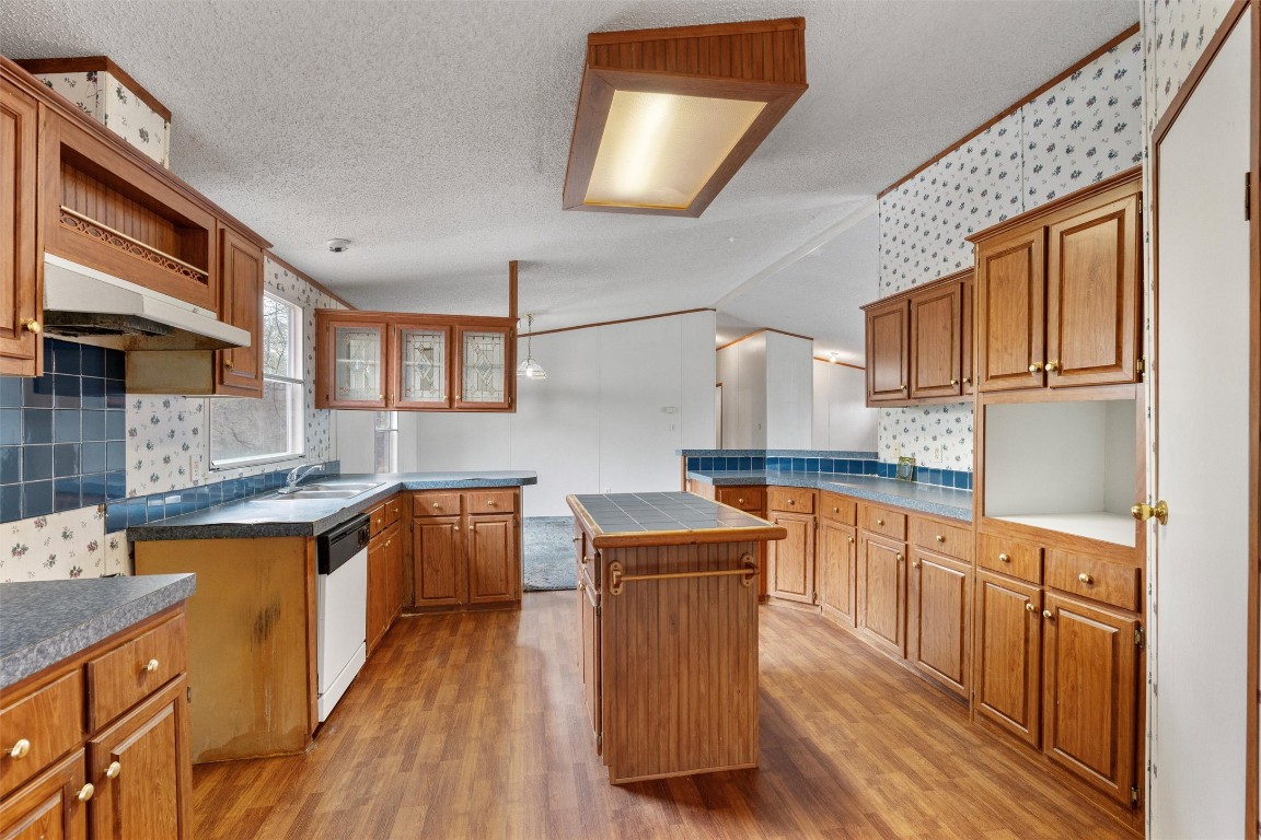 1100 County Road 474 Elgin, TX 78621 - Photo 18 of 40 a kitchen with stainless steel appliances granite countertop a sink stove and wooden cabinets
