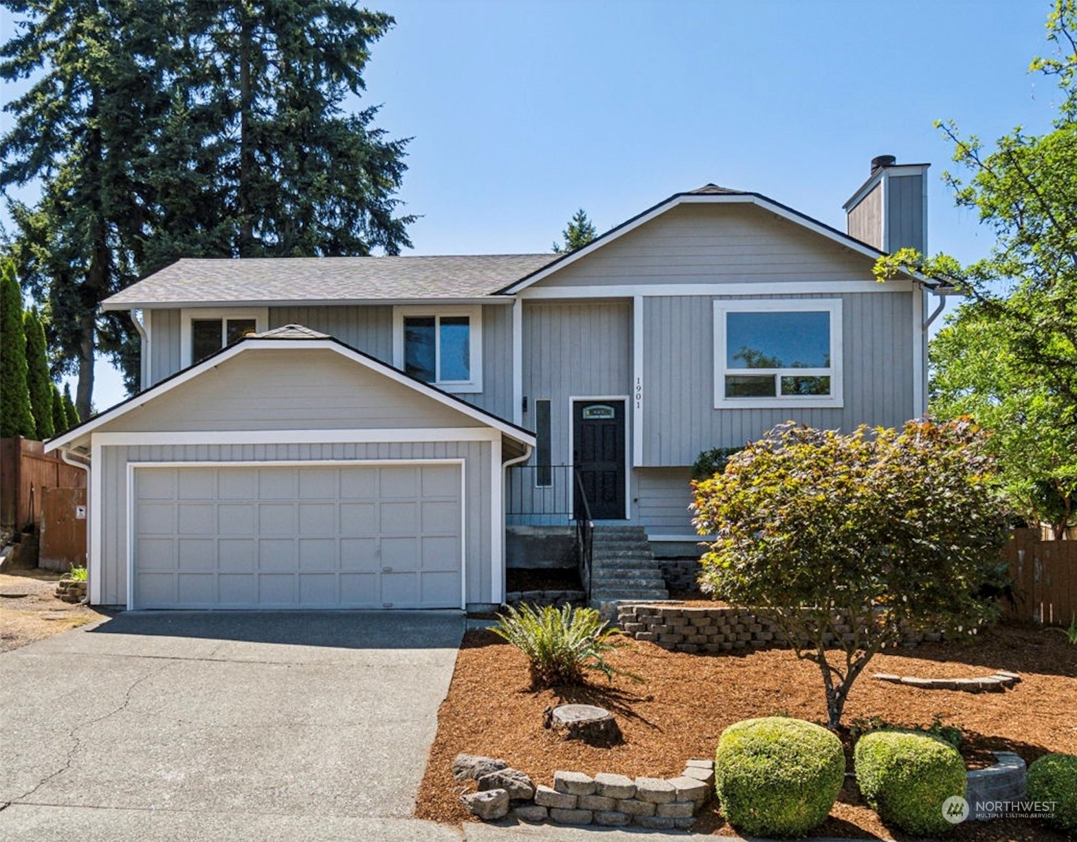 1901 Northeast 17th Place Renton, WA 98056 - Photo 1 of 40 a front view of a house with a yard and garage