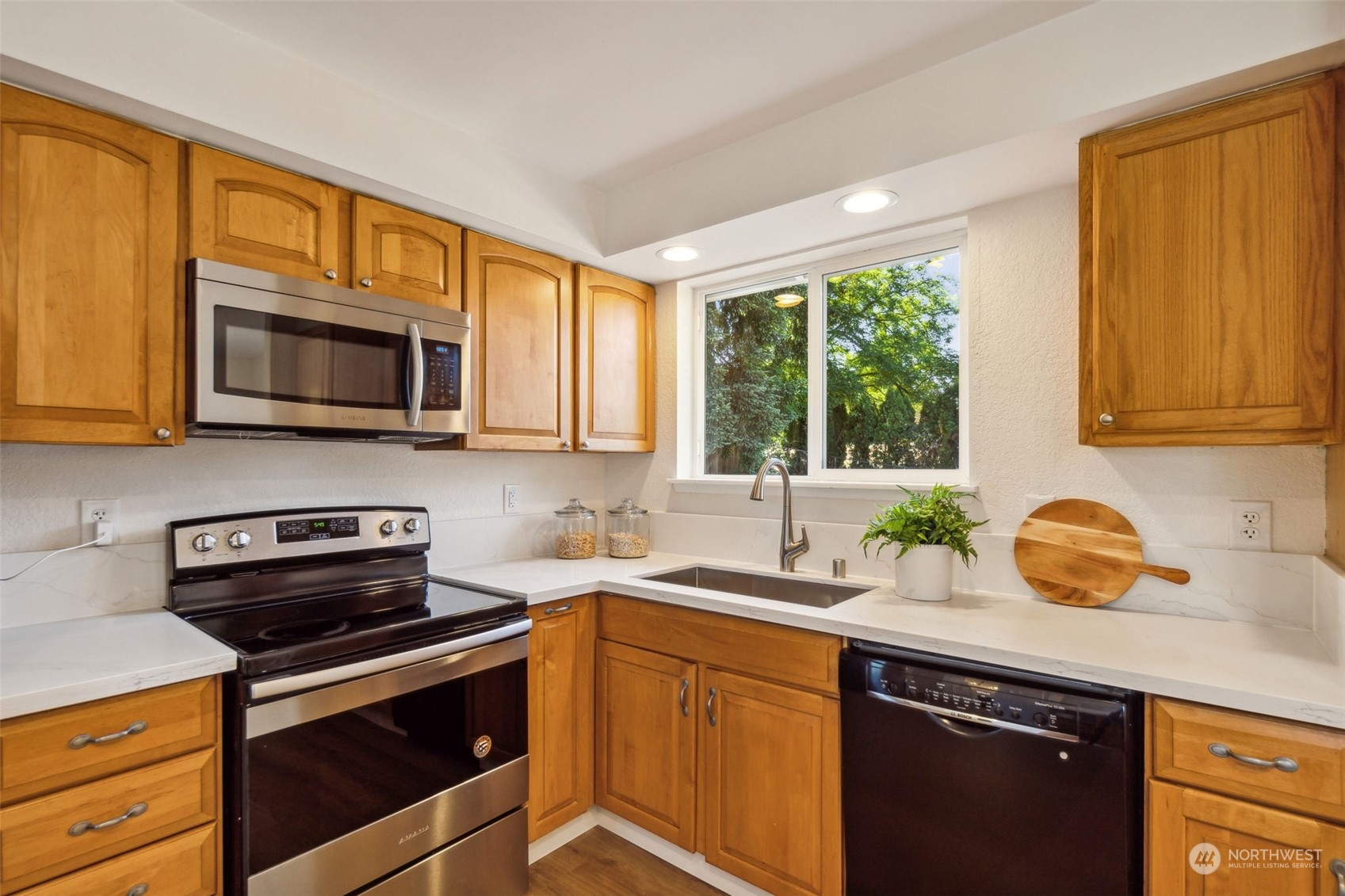 1901 Northeast 17th Place Renton, WA 98056 - Photo 12 of 40 a kitchen with a sink stove top oven and cabinets