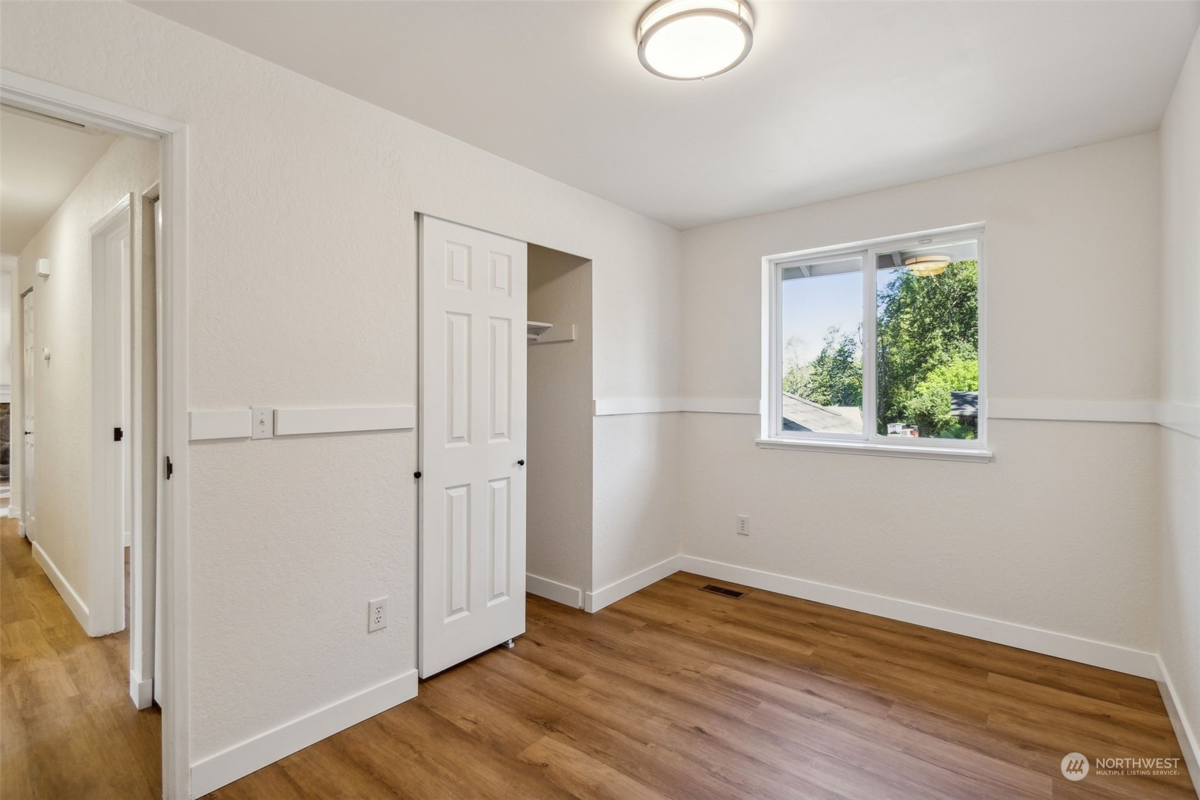 1901 Northeast 17th Place Renton, WA 98056 - Photo 22 of 40 an empty room with wooden floor cabinet and windows
