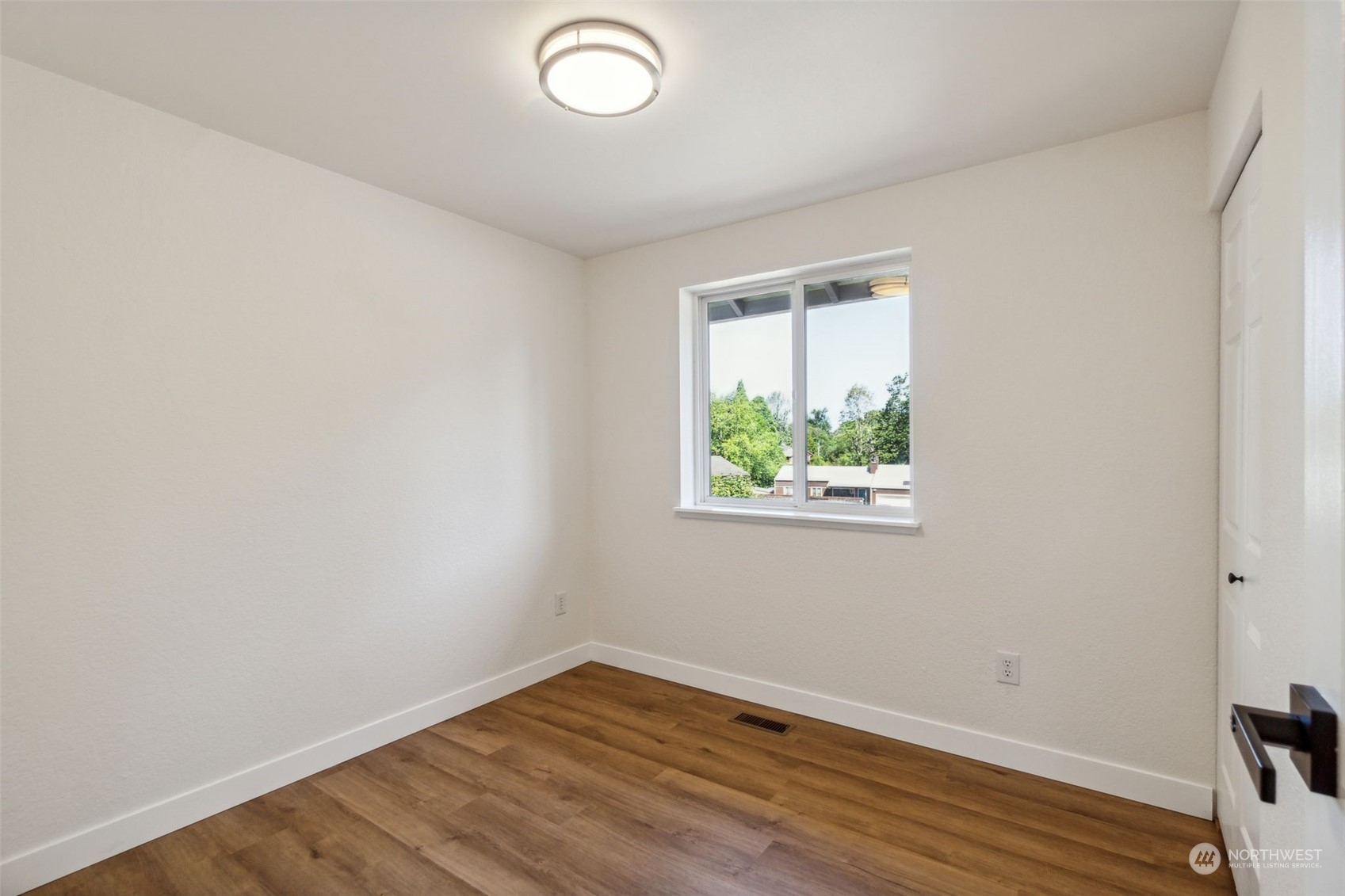 1901 Northeast 17th Place Renton, WA 98056 - Photo 23 of 40 an empty room with wooden floor and windows