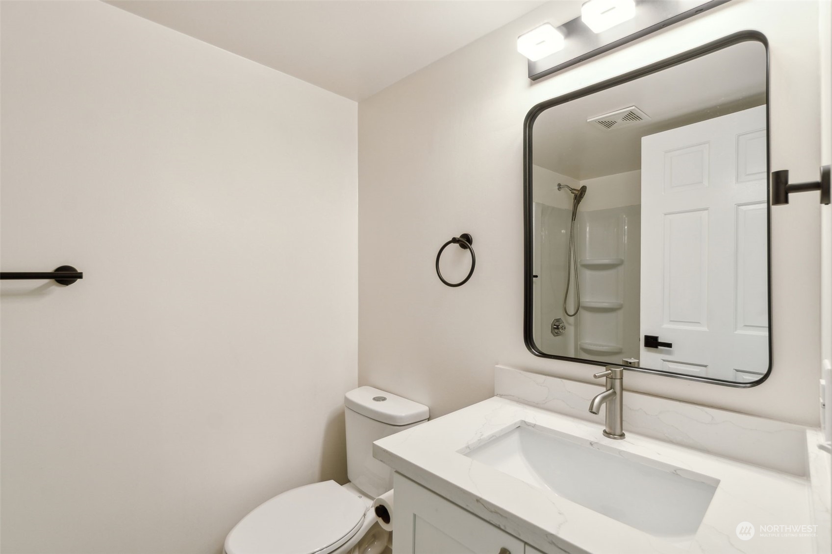 1901 Northeast 17th Place Renton, WA 98056 - Photo 25 of 40 a bathroom with a sink a toilet and a mirror