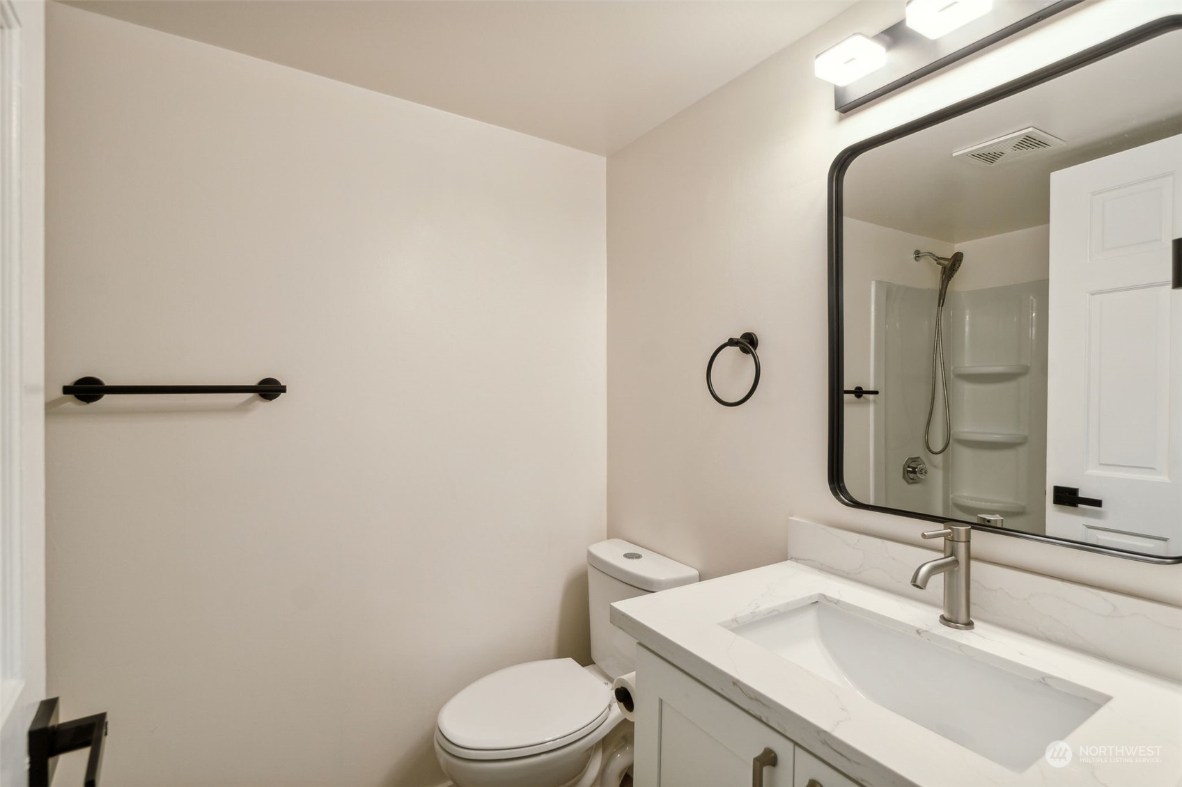 1901 Northeast 17th Place Renton, WA 98056 - Photo 26 of 40 a bathroom with a toilet sink vanity and mirror