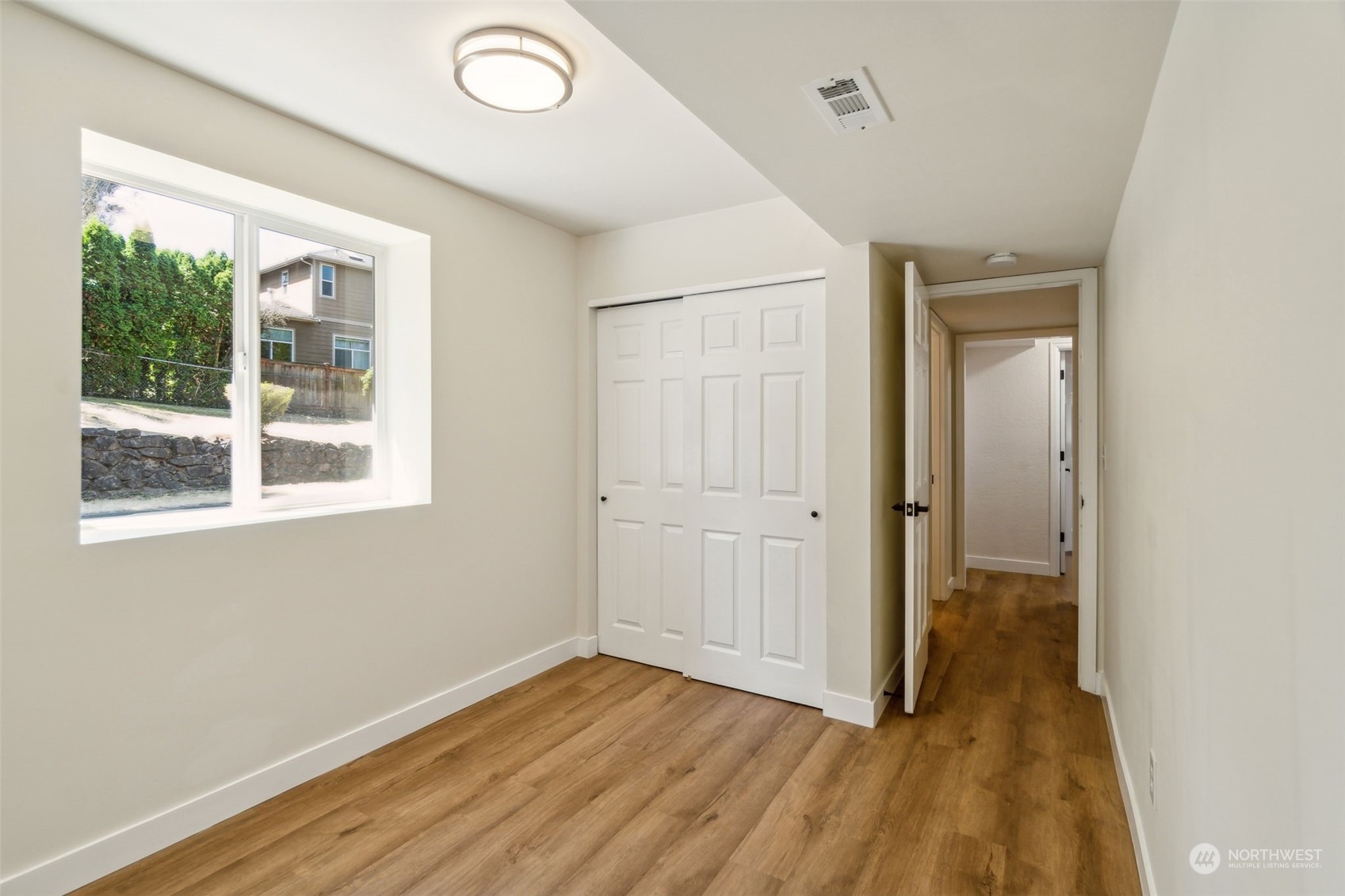 1901 Northeast 17th Place Renton, WA 98056 - Photo 28 of 40 a view of an empty room with wooden floor and a window