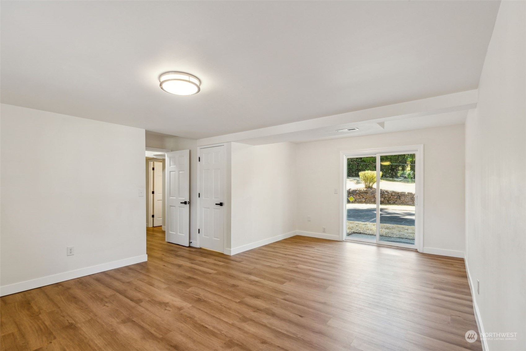 1901 Northeast 17th Place Renton, WA 98056 - Photo 31 of 40 an empty room with wooden floor and windows