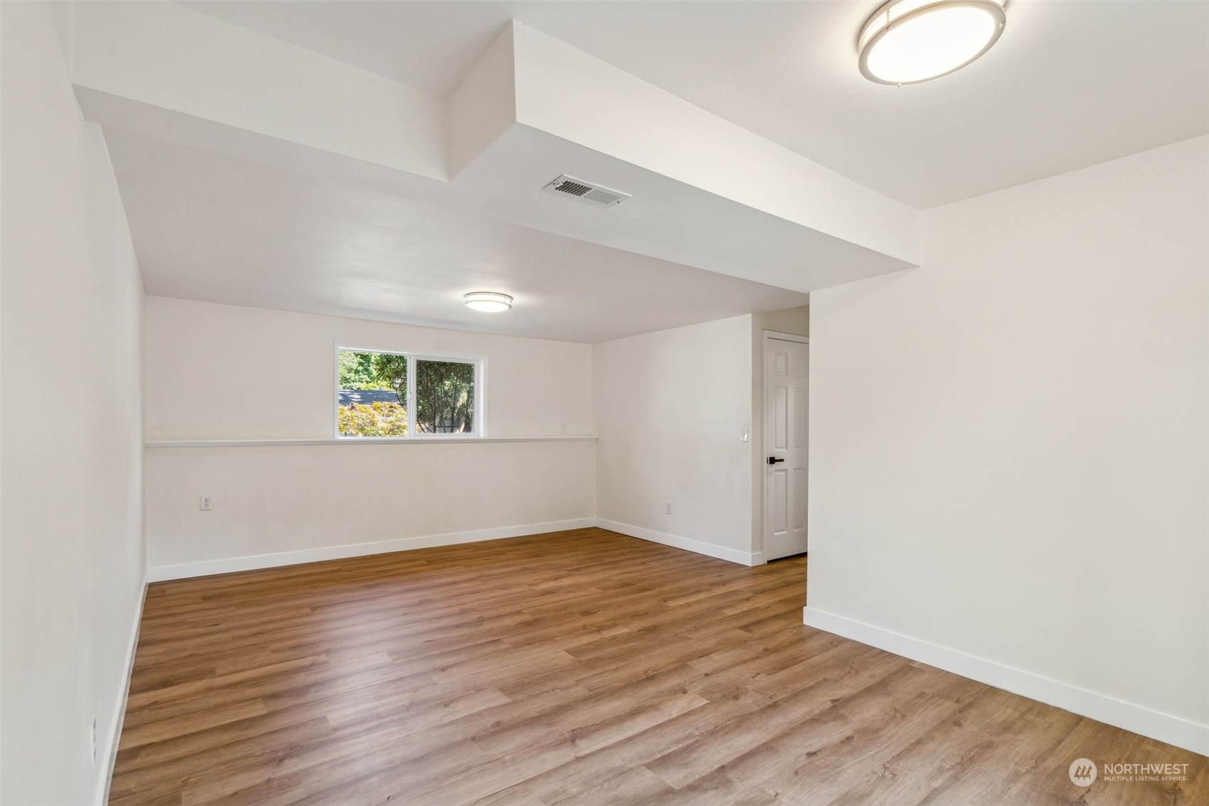 1901 Northeast 17th Place Renton, WA 98056 - Photo 33 of 40 an empty room with wooden floor and windows
