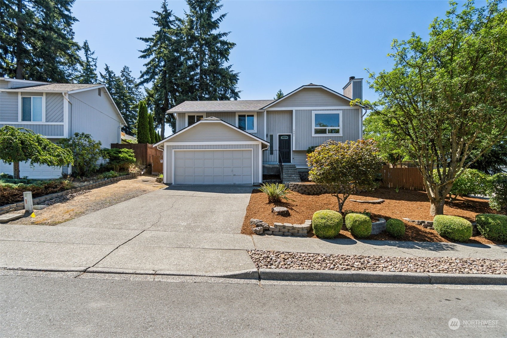 1901 Northeast 17th Place Renton, WA 98056 - Photo 37 of 40 a front view of a house with a garden and plants