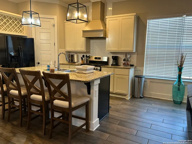 a kitchen with a sink cabinets and wooden floor