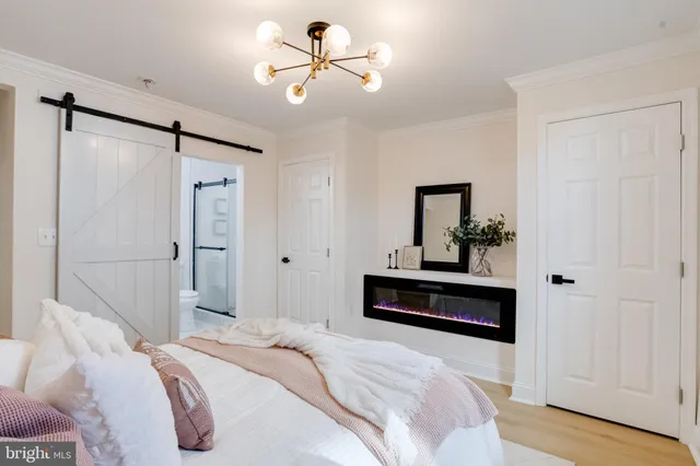 a bedroom with a bed and a chandelier