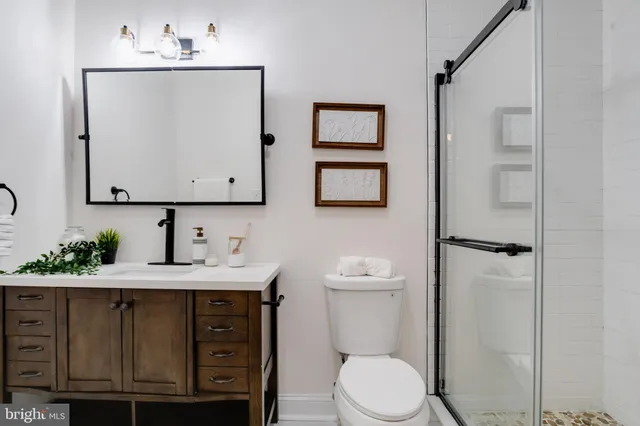 a bathroom with a sink a toilet and mirror