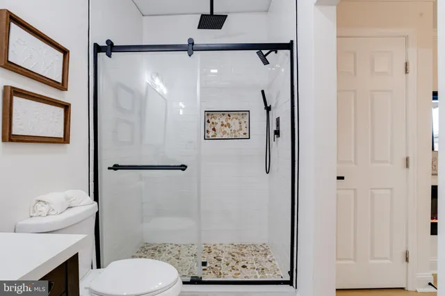 a bathroom with a toilet sink and shower