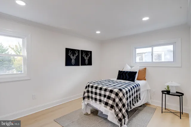 a bedroom with a bed lamp and a window
