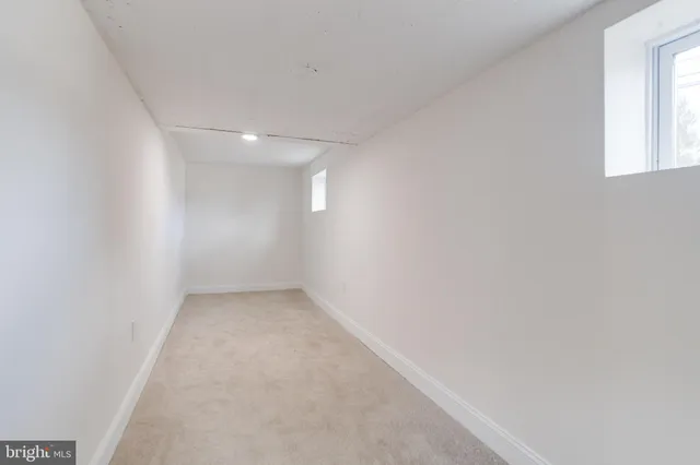 an empty room with a empty space and windows