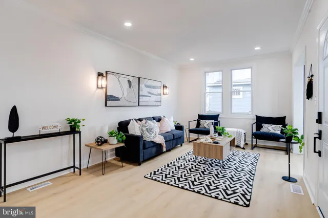 a living room with furniture rug and window