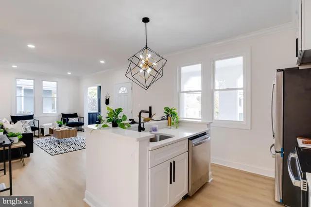a very nice looking dining room with a window furniture and a chandelier