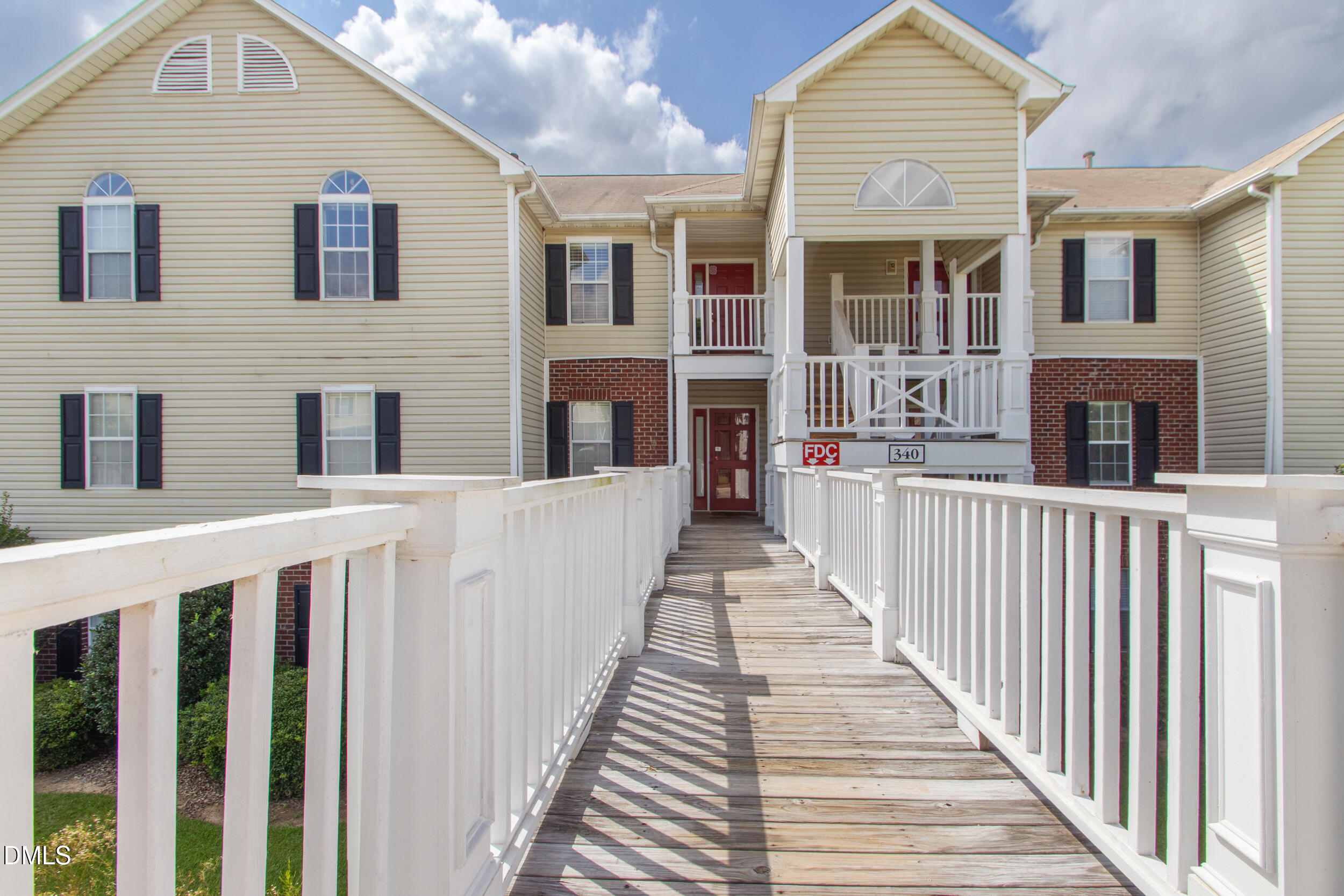 a view of a house with wooden fence