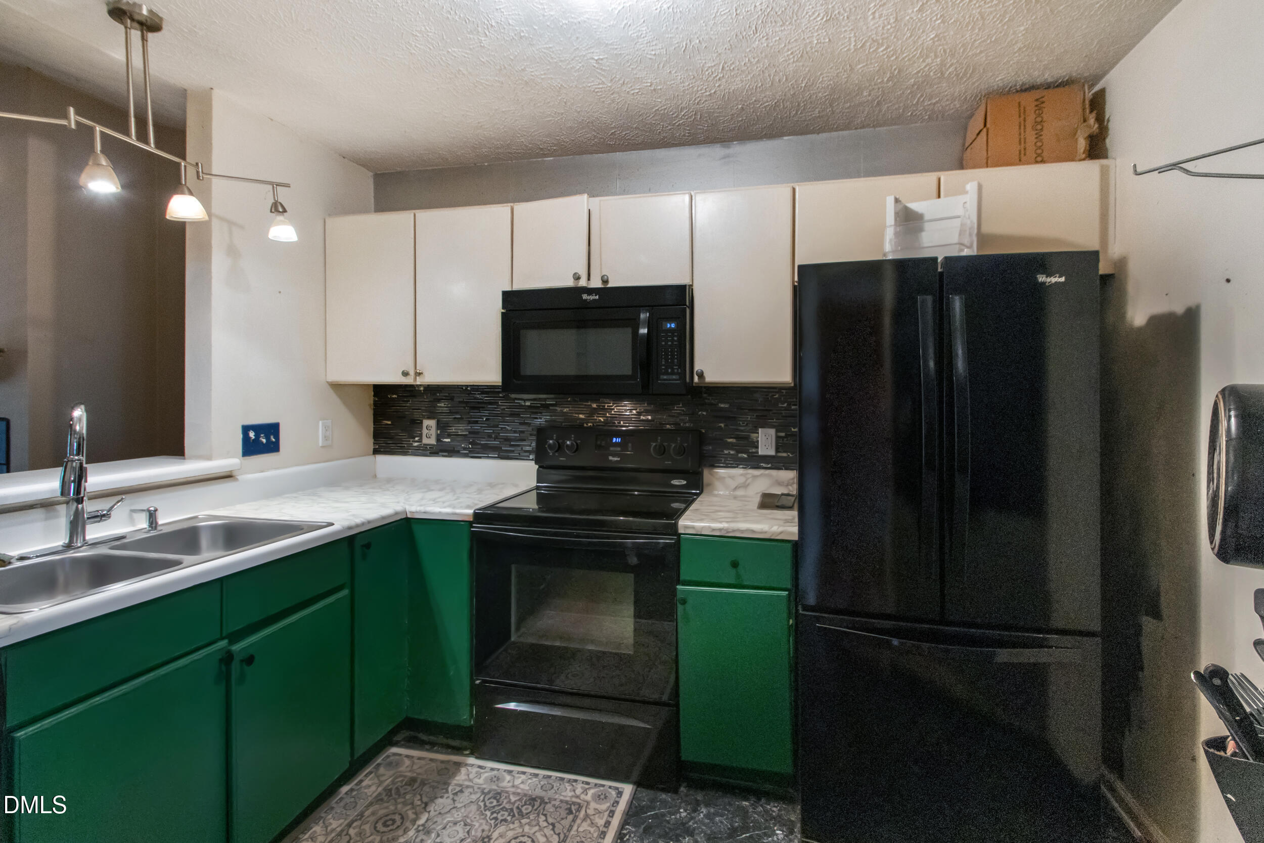 340 Bubble Creek Court, Unit 11 Fayetteville, NC 28311 - Photo 15 of 28 a kitchen with a refrigerator and a sink