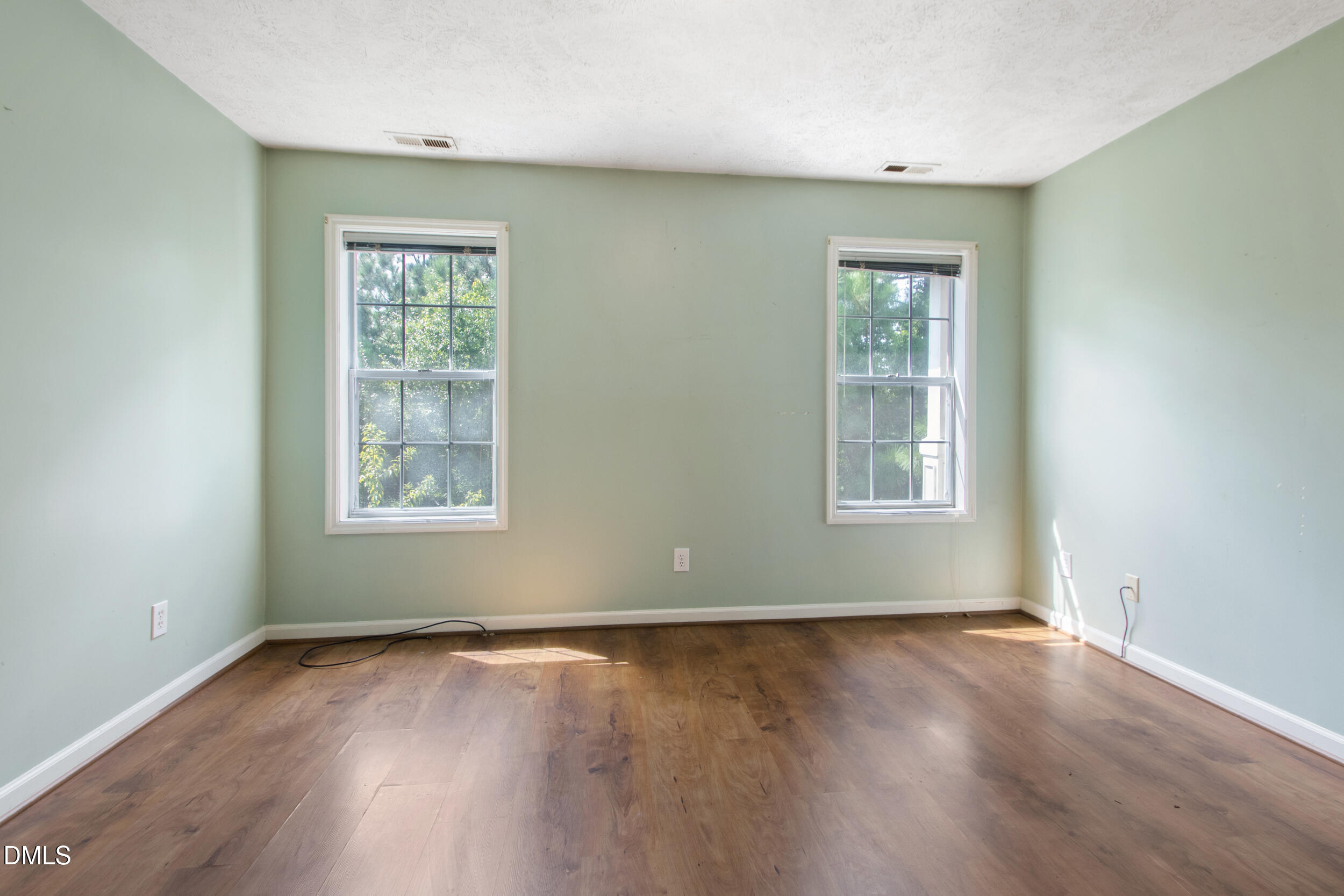 340 Bubble Creek Court, Unit 11 Fayetteville, NC 28311 - Photo 17 of 28 an empty room with wooden floor and windows