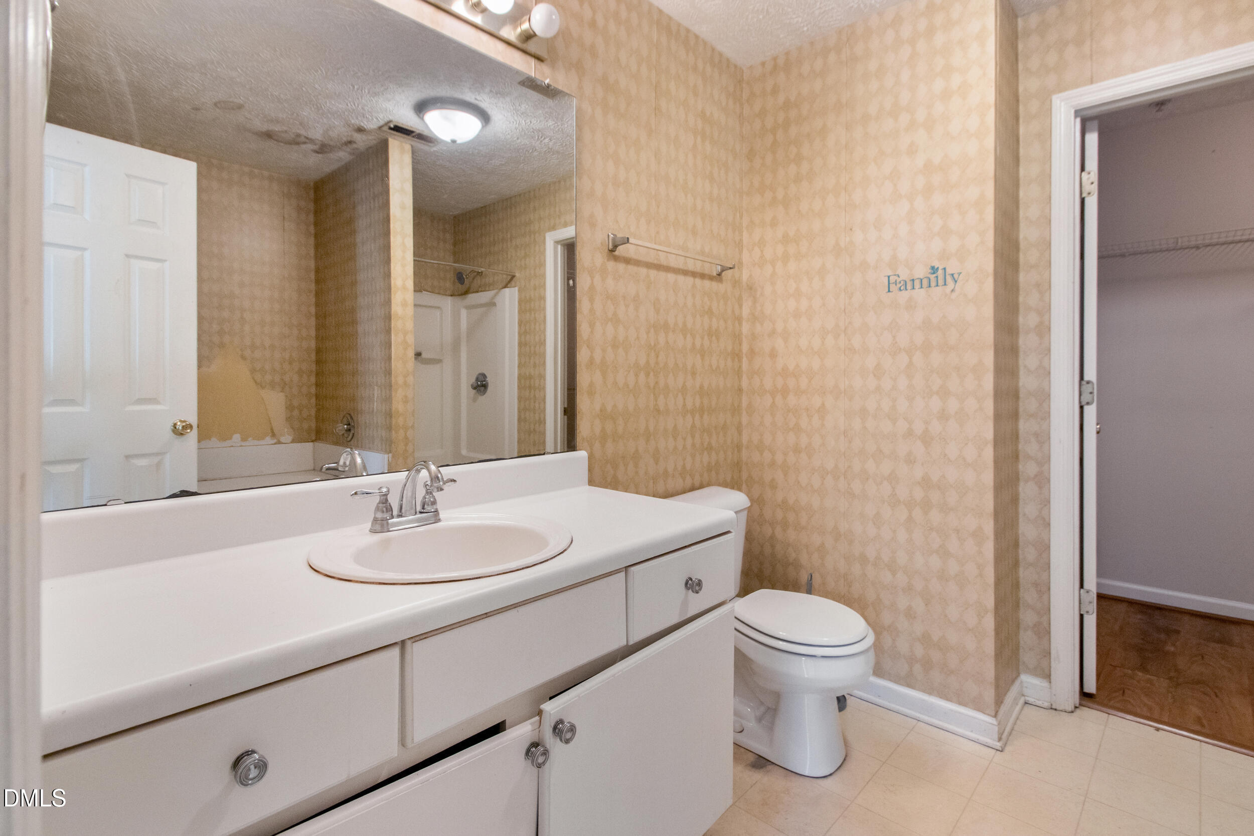 340 Bubble Creek Court, Unit 11 Fayetteville, NC 28311 - Photo 19 of 28 a bathroom with a toilet a sink a mirror and a shower