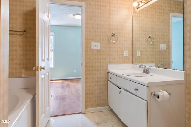 a bathroom with a toilet a sink a mirror and a shower