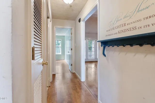 a view of a bedroom with window and hardwood floor