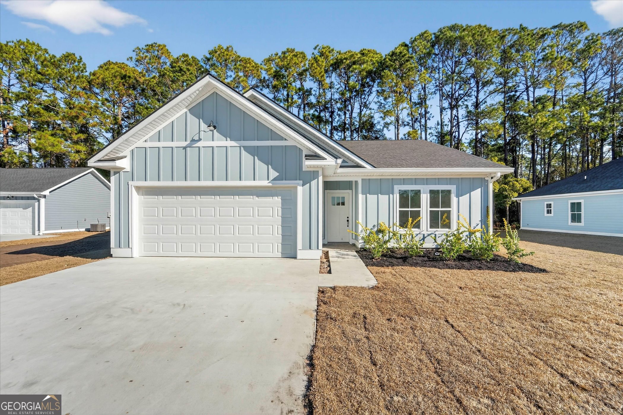 1072 Cottage Way Darien, GA 31305 - Photo 1 of 13 a front view of a house with a yard and garage