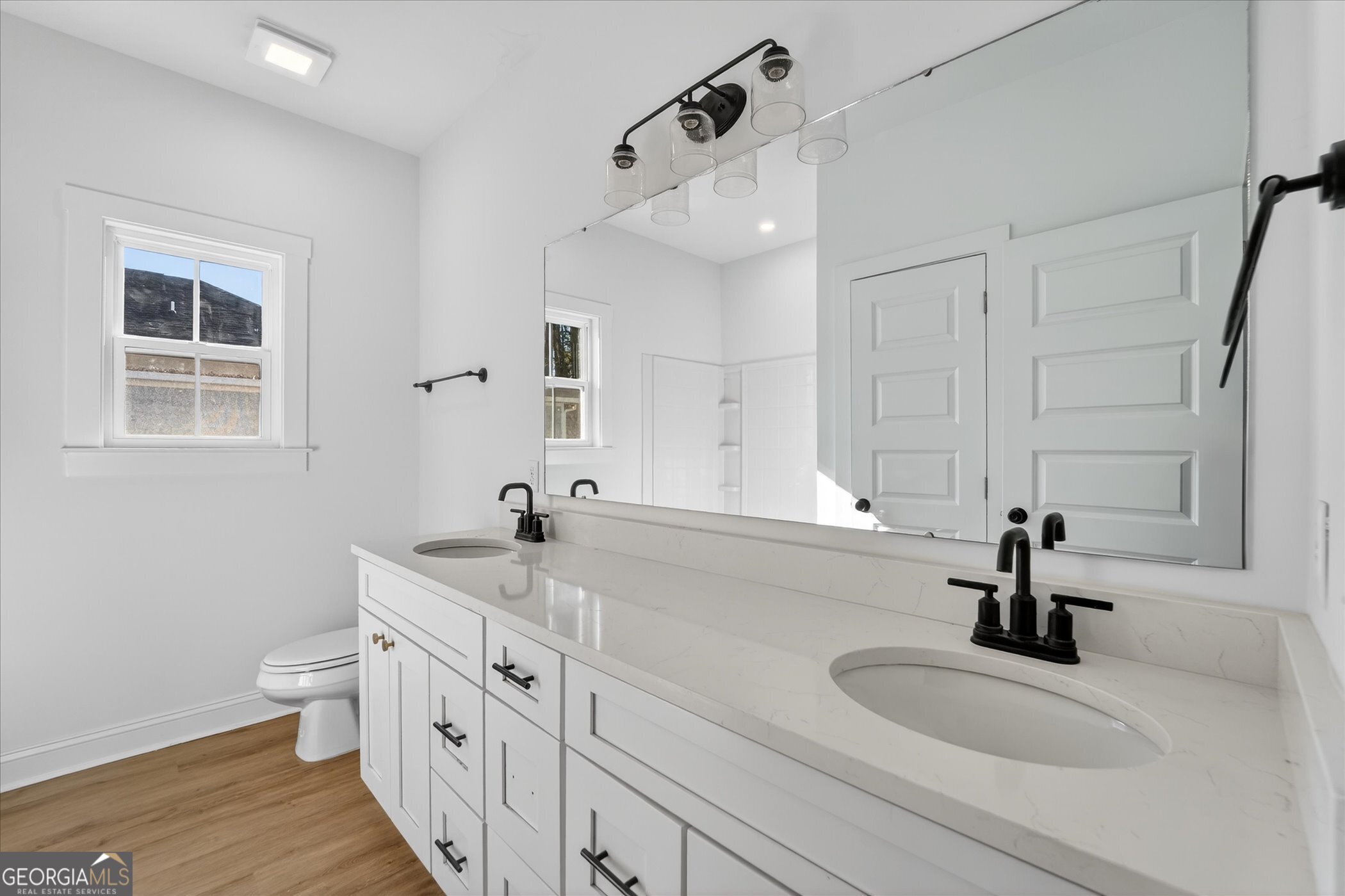 1072 Cottage Way Darien, GA 31305 - Photo 11 of 13 a bathroom with double vanity sink a mirror and a toilet