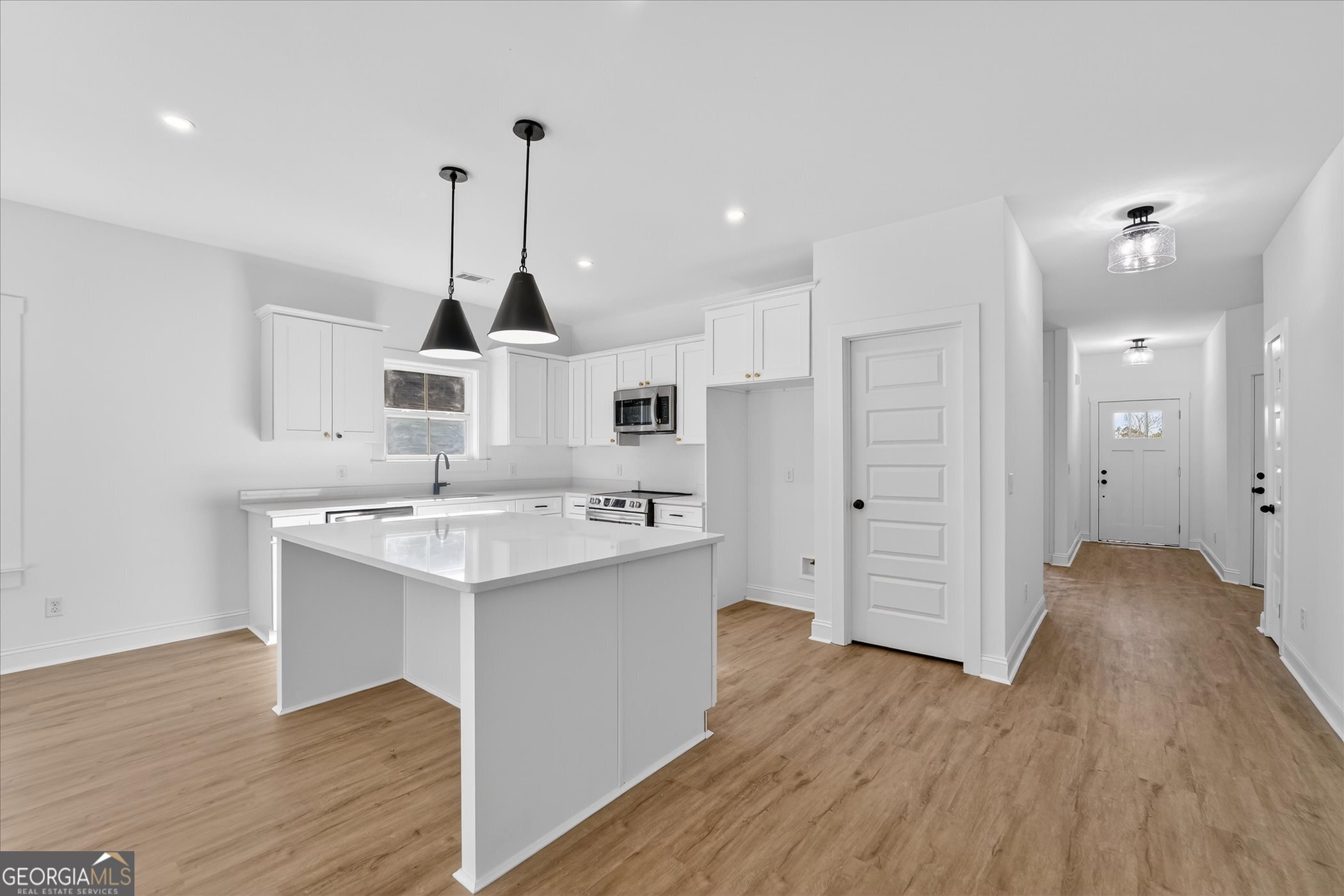1072 Cottage Way Darien, GA 31305 - Photo 3 of 13 a kitchen with stainless steel appliances granite countertop a sink stove and wooden floor