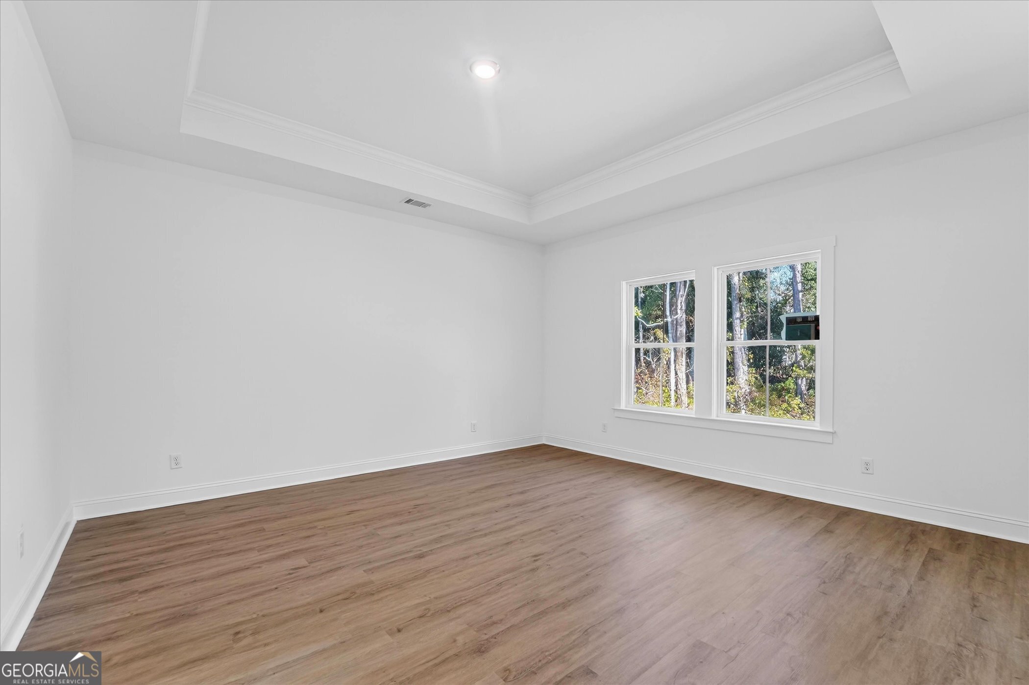 1072 Cottage Way Darien, GA 31305 - Photo 6 of 13 an empty room with wooden floor and windows