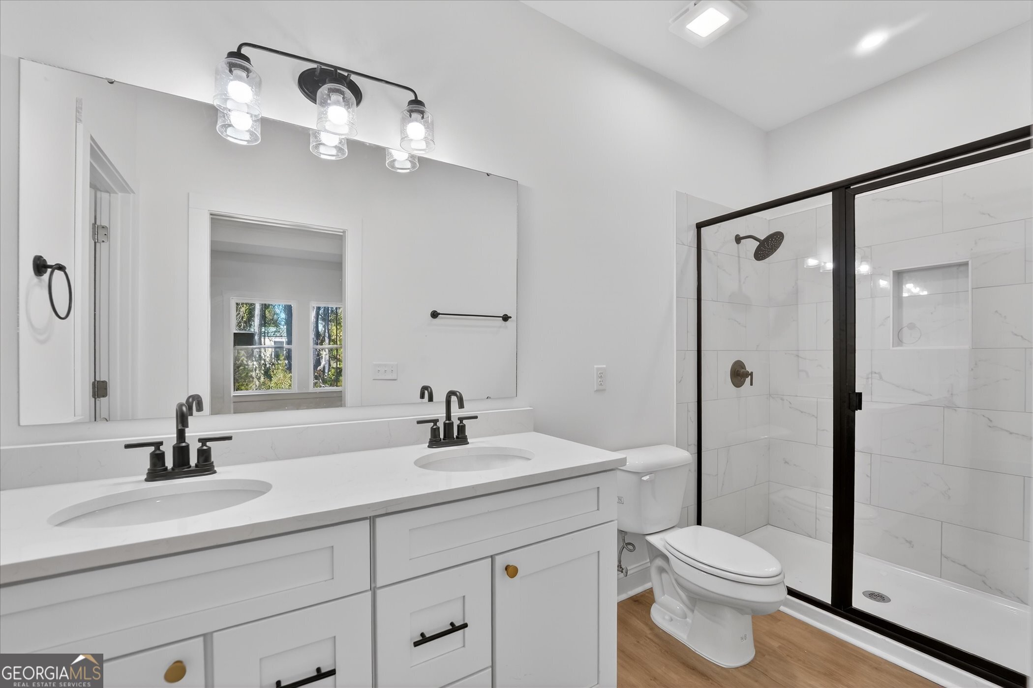 1072 Cottage Way Darien, GA 31305 - Photo 7 of 13 a bathroom with a toilet a sink a mirror and shower