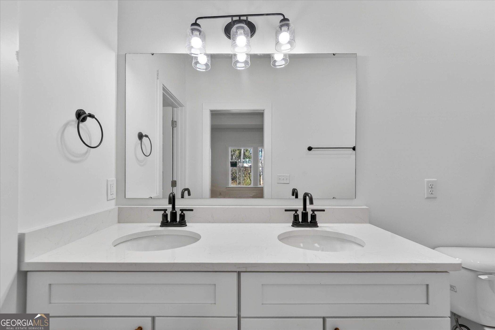 1072 Cottage Way Darien, GA 31305 - Photo 8 of 13 a bathroom with a sink and a mirror